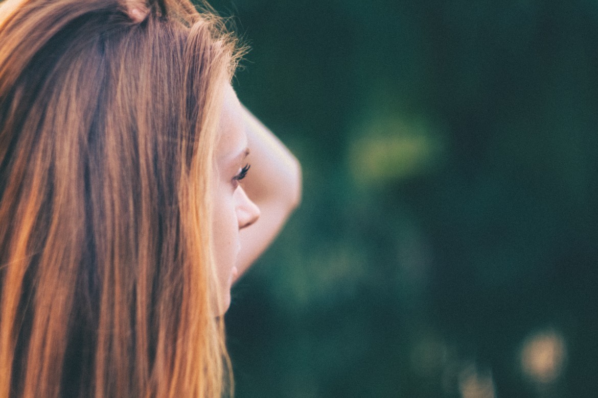 girl looking sideways, green background